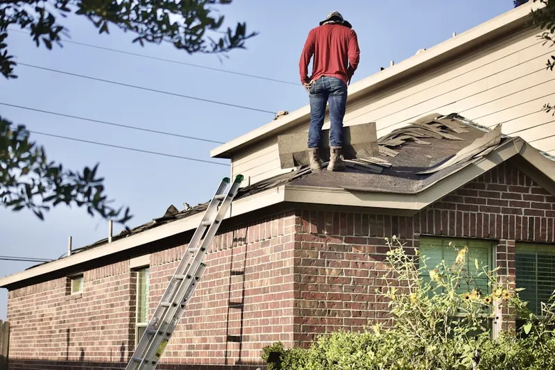 Professional roofer working on a residential roof in Charlestown